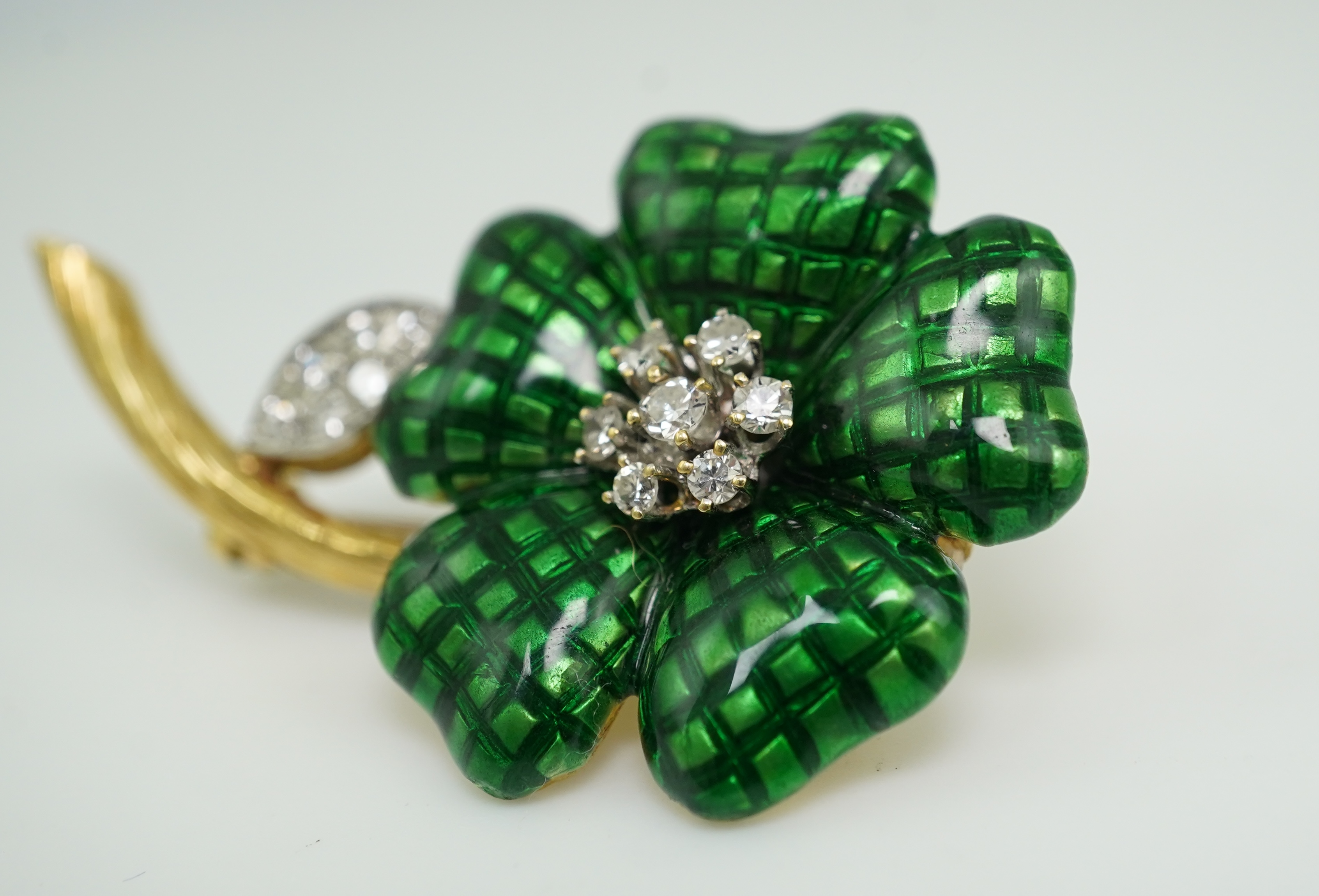An enamel and diamond brooch